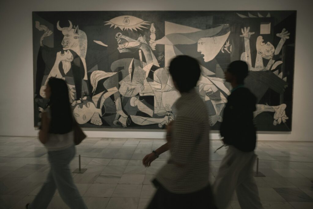 People walk past a large abstract painting