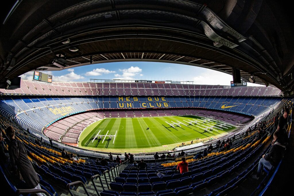 a large stadium with a green field